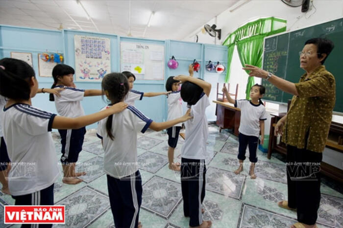 Cô Ngời hướng dẫn các em khiếm thính khác trong giờ học giáo dục thể chất tại trường.