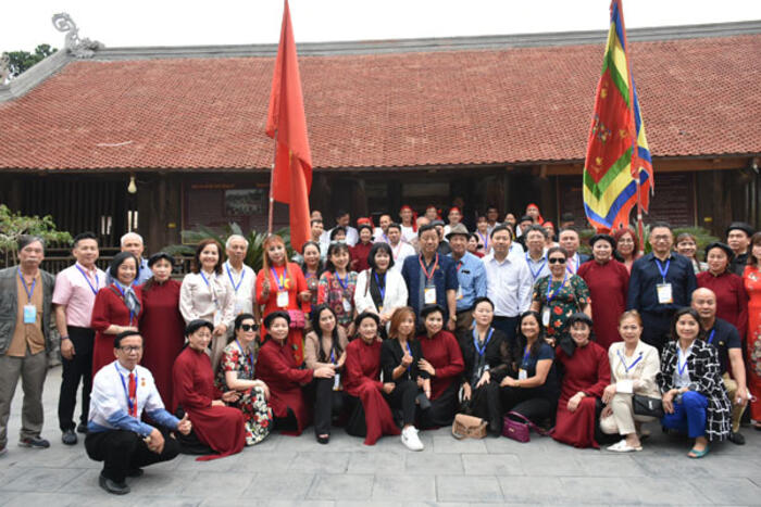 Các đại biểu kiều bào chụp ảnh lưu niệm cùng các nghệ nhân hát xoan làng Hùng Lô