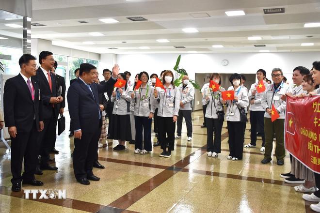 Lao động Việt Nam chào đón Phó Thủ tướng Nguyễn Chí Dũng và đoàn công tác đến thăm nhà máy Yokkaichi của Tập đoàn Kioxia tại tỉnh Mie. (Ảnh: Nguyễn Tuyến/TTXVN) ttxvn-hoat-dong-cua-pho-thu-tuong-nguyen-chi-dung-tai-nhat-ban8.jpg