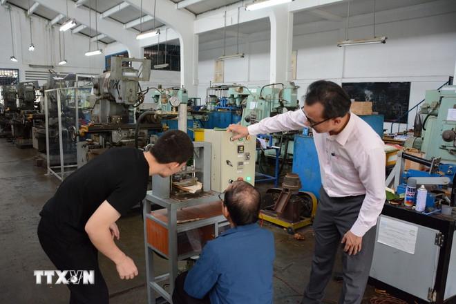 Giảng viên trường Đại học Sư phạm Kỹ thuật-Đại học Đà Nẵng hướng dẫn sinh viên chế tạo sản phẩm khoa học. (Ảnh: Văn Dũng/TTXVN) ttxvn-dau-tu-cho-khoa-hoc.jpg